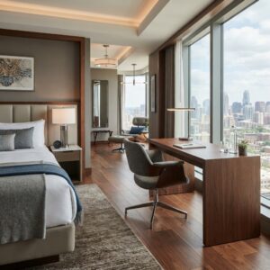 Ergonomic hotel bedroom desk chair featuring a curved wood shell and swivel base inside a modern high-rise suite